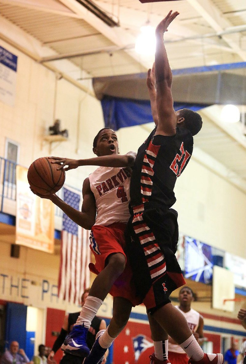 Little Rock Parkview’s Daryl Macon (4) tries to put up a shot over Fort Smith Northside’s Benow Stevenson during the Patriots’ 83-50 victory over the Grizzlies on Friday in Little Rock. 