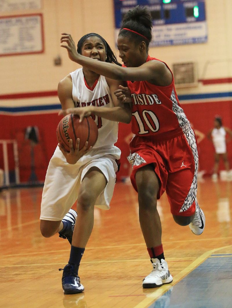 Little Rock Parkview’s Christyal Holloway (left) tries to get past Fort Smith Northside defender Brianna Jackson (10) during the Lady Patriots’ 57-55 victory over the Lady Grizzlies on Friday at Charles Ripley Arena in Little Rock. Holloway and Jackson ÿnished with eight points each. 