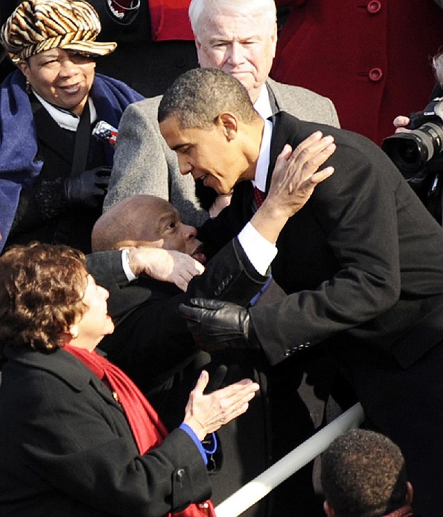 President Barack Obama greets civil-rights activist Rep. John Lewis, D-Ga., on the Capitol steps before taking the oath of office for his first term Jan. 20, 2009, in Washington. 