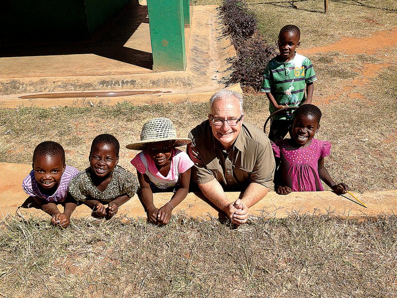 Doug Sarver, minister of global missions at Cross Church, poses with children at Esther’s House orphanage in Malawi, Africa. The orphanage is one of many locations Sarver visited last year.