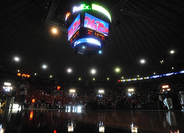The overhead scoreboard and emergency lights illuminate the court after the main lights went out at the main lights at the C.M. "Tad" Smith Coliseum during the first half of an NCAA college basketball game between Arkansas and Mississippi in Oxford, Miss., on Saturday, Jan. 19, 2013. (AP Photo/Oxford Eagle, Bruce Newman)