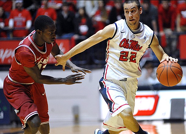 Mississippi's Marshall Henderson (22) drives against Arkansas' Fred Gulley (12) during an NCAA college basketball game in Oxford, Miss. on Saturday, Jan. 19, 2013. (AP Photo/Oxford Eagle, Bruce Newman)