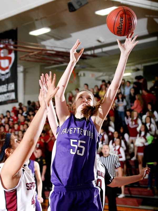 Lauren Schuldt, Fayetteville sophomore, puts up a shot Friday around Springdale High junior Karen Perez at Springdale High School. 