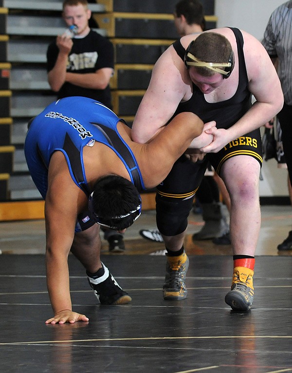 Jared Conover  of Bentonville attempts to flip Rogers High’s Josue Oscoy on Saturday at Bentonville High School during the Bentonville Tiger Classic. Conover wrestles in the 285-pound weight class.