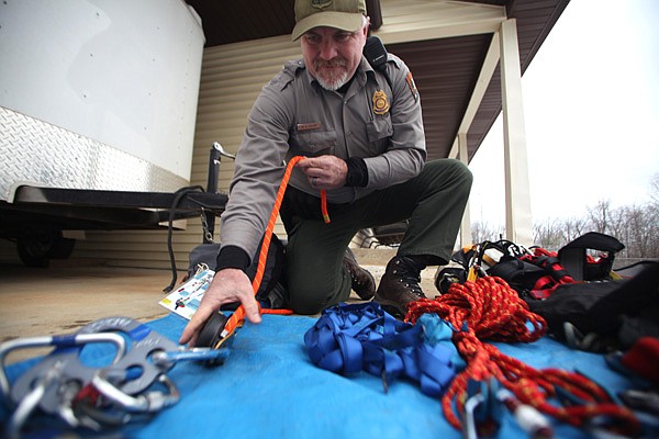 Mark Miller, Upper Buffalo District Ranger, demonstrates an inventory of high angle search and rescue gear used by members of various search and rescue teams covering Newton and surrounding counties. Jan. 21, members of search and rescue teams from Newton, Madison and Carroll counties will meet in Jasper for the inaugural training session of the new Tri-County Search and Rescue, which will combine resources to serve all three areas. 