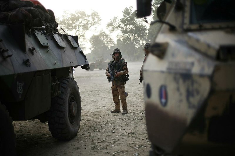 A French soldier stands guard Saturday as his unit enters Niono, about 300 miles north of Mali’s capital, Bamako. 