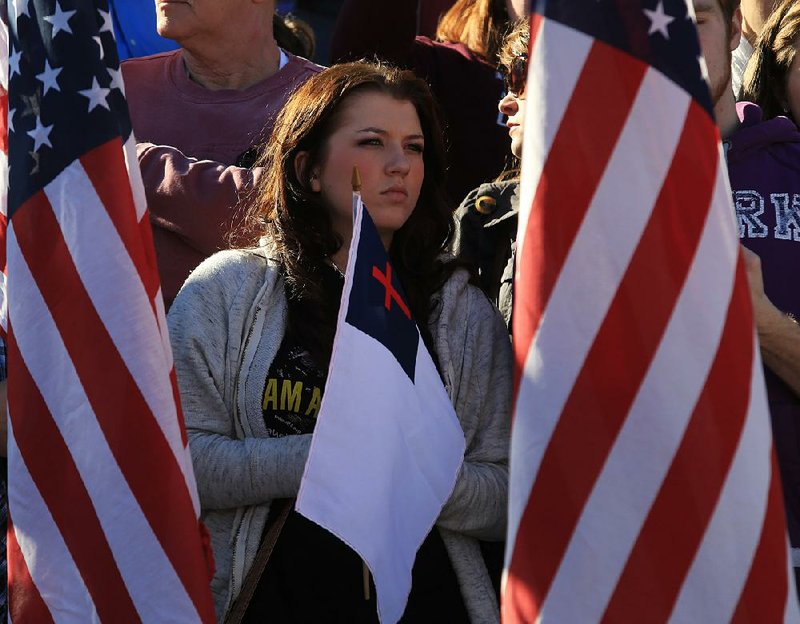 Alexis St. Clair of Hot Springs listens to the program Sunday afternoon at the 35th annual March for Life at the state Capitol in Little Rock. 