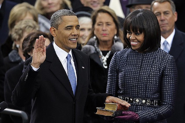 President Barack Obama receives the oath of office from Chief Justice John Roberts (not seen) as Michelle Obama holds Bibles on Monday at the ceremonial swearing-in at the U.S. Capitol during the 57th presidential inauguration in Washington. The top Bible, which Obama used in his inauguration in 2009, belonged to Abraham Lincoln. The bottom one was Martin Luther King Jr.’s. 