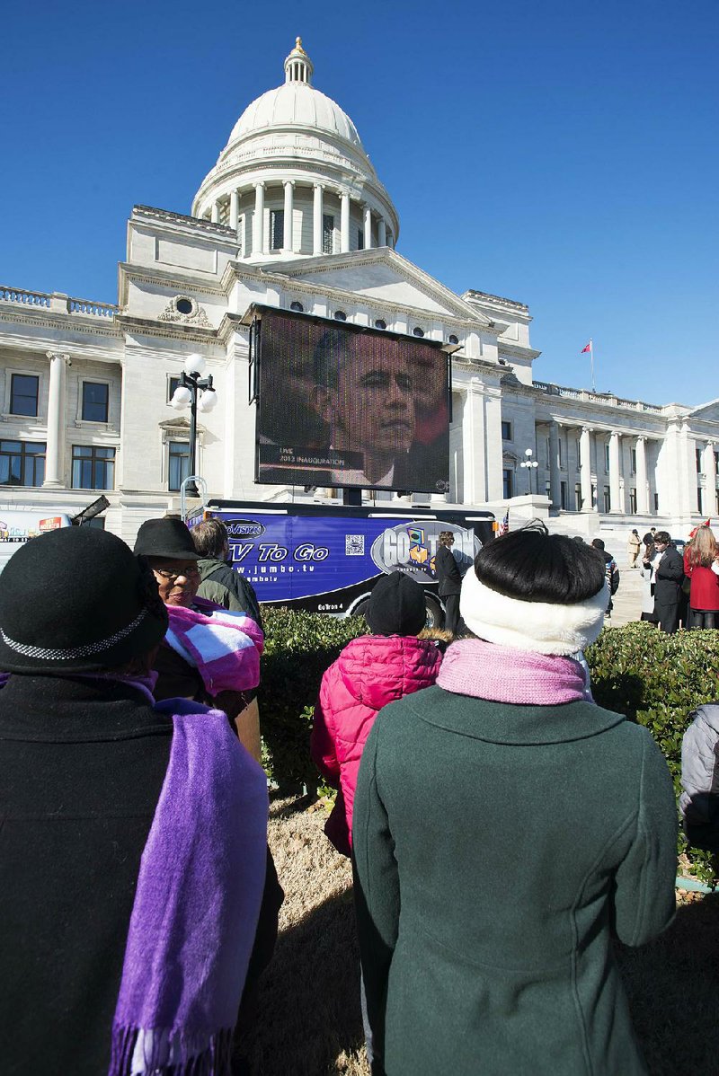 Spectators gather in front of the Arkansas State Capitol to watch President Barack Obama’s ceremonial inauguration, which was supposed to be broadcast live on a jumbo TV monitor. Technical problems delayed the broadcast by at least 10 minutes. 