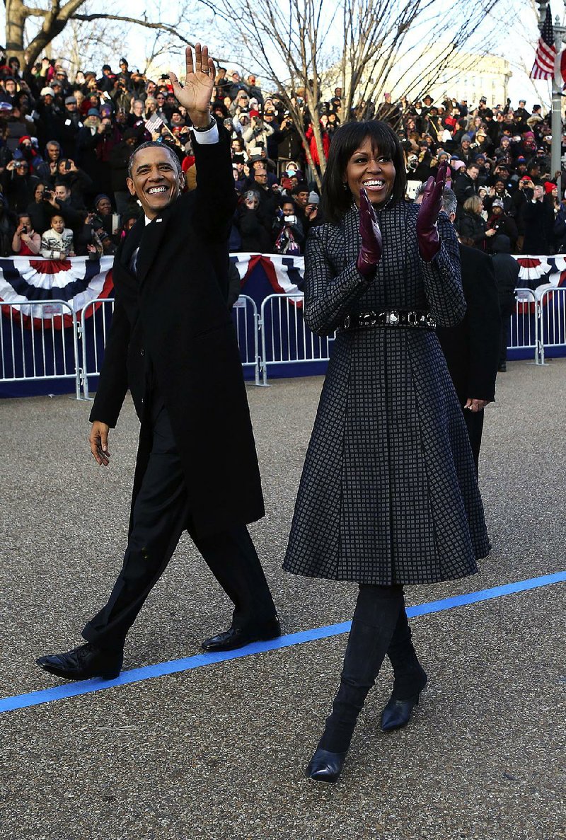 President Barack Obama and first lady Michelle Obama walk down Pennsylvania Avenue on Monday in Washington. 