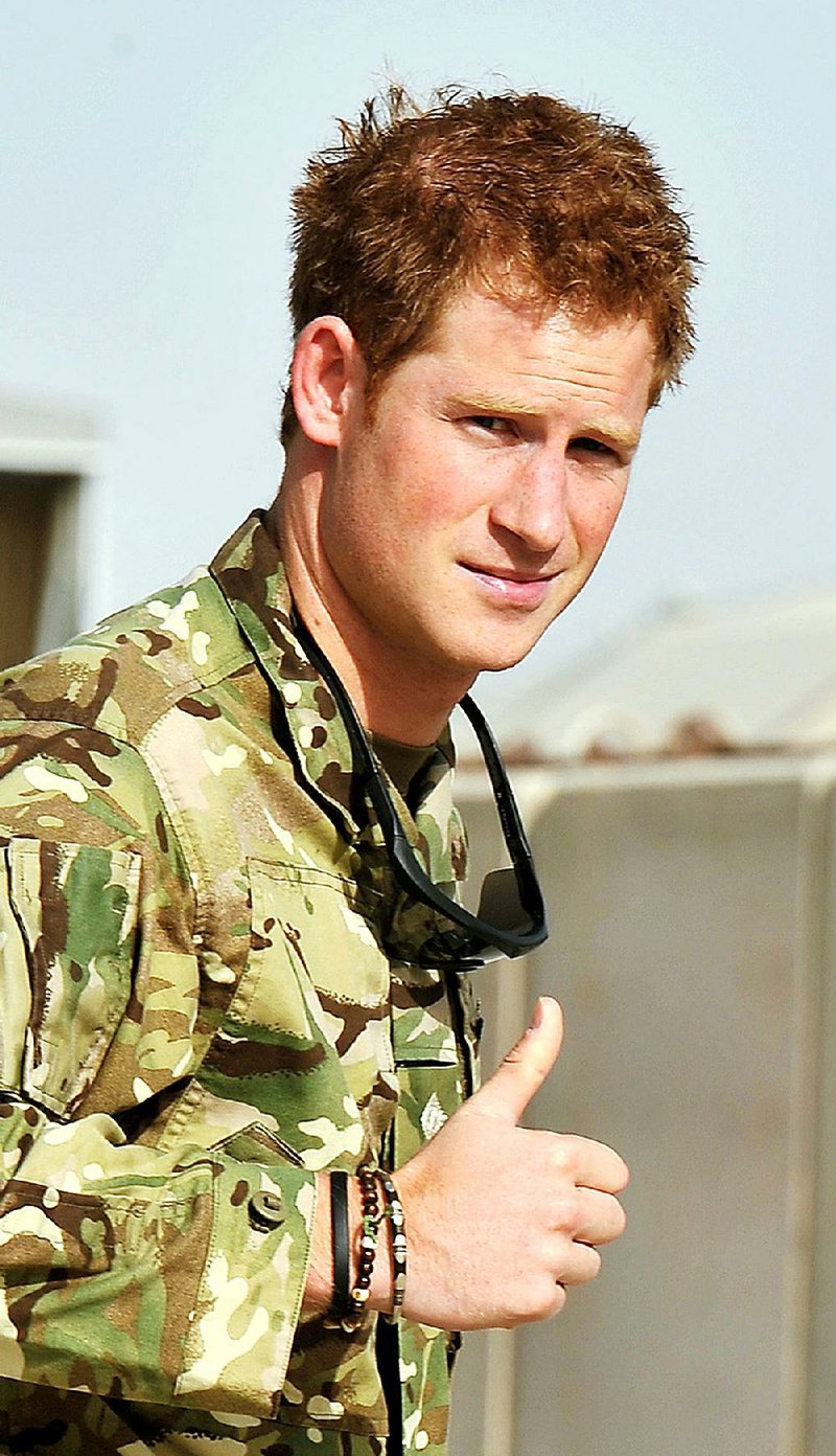 Britain's Prince Harry gives a thumbs up Friday Sept. 7, 2012 after he walked past the Apache flight-line at Camp Bastion in Afghanistan. 