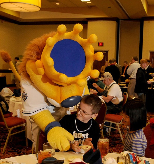 Lucas McDaniel, 10, of Springdale tries to keep Sluggerrr, the Kansas City Royals mascot, out of his ice cream Monday as Emily McDaniel, 9, watches during the 2013 Royals Caravan at the Springdale Rotary Club at the Holiday Inn in Springdale. The caravan featured former Royal Dennis Leonard and current players Bruce Chen, Danny Duffy and Will Smith. Royals owner David Glass also talked to members of the club and invited guests. 