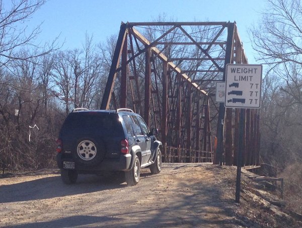 A vehicle drives southbound Monday onto the Harvey Dowell Bridge on Washington County Road 195. County road crews today closed roads to the north and south of the bridge in preparation to replace the structure built in 1926. 