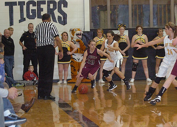 MARK HUMPHREY STAFF PHOTO -- Lincoln's Bailey Heffley is pressured in the corner by Prairie Grove's Abby Smith. Prairie Grove defeated Lincoln, 56-42, Tuesday night as the U.S. 62 rivals met.