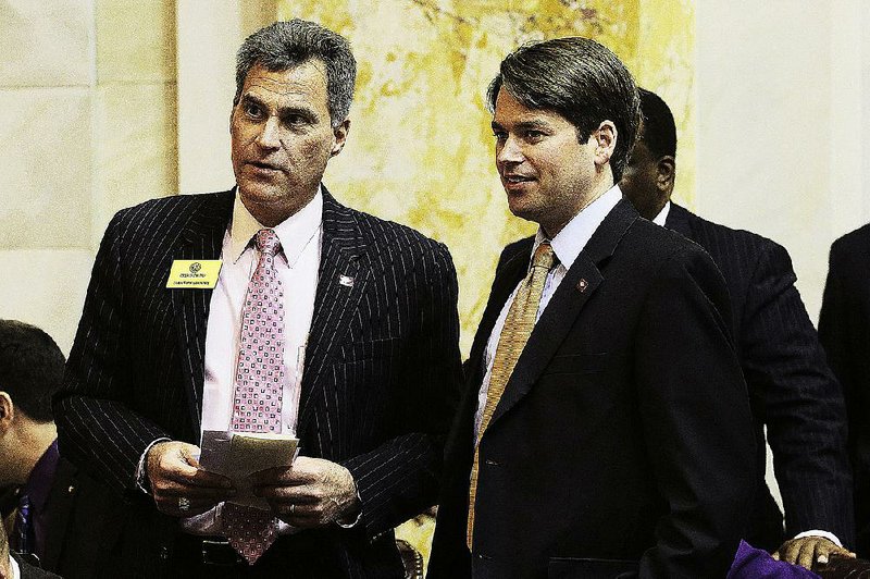 Rep. Charlie Collins, R-Fayetteville, left, talks with Rep. Duncan Baird, R-Lowell, in the House chamber at the Arkansas state Capitol in Little Rock, Ark., Tuesday, Jan. 22, 2013. (AP Photo/Danny Johnston)