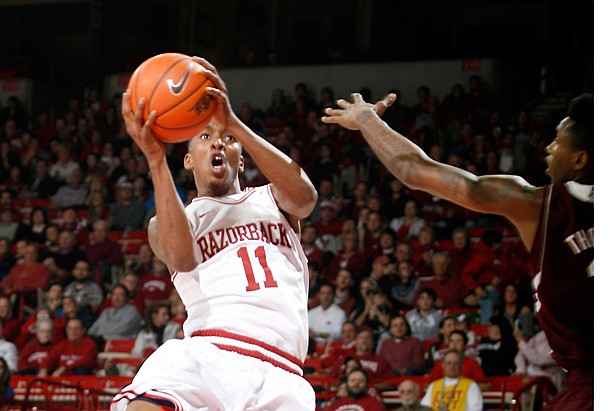 Arkansas sophomore BJ Young attempts a shot around Mississippi State freshman Fred Thomas on Wednesday, Jan. 23, 2013, at Bud Walton Arena in Fayetteville.