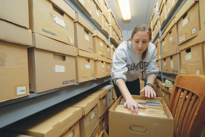 Anna Grace Poole sorts archived student records at Ouachita Baptist University in Arkadelphia. The records are just the beginning of the items the university has taken in as part of its Special Collections.