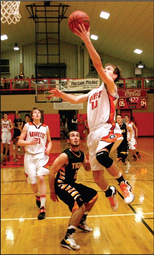 Gravette junior forward Terence Pierce makes a break for a layup in Friday's game against Prairie Grove in the Gravette Lions field house. Pierce was guarded by Prairie Grove junior J.D. Speed. 