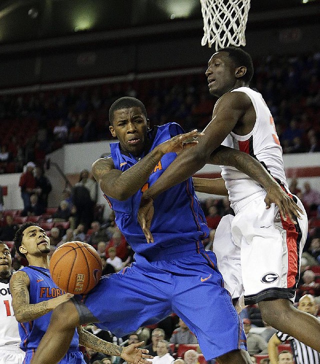 Florida guard Kenny Boynton (1) is fouled by Georgia forward Brandon Morris (right) as he drives to the basket during the second half of the No. 8 Gators’ 64-47 victory over the Bulldogs on Wednesday in Athens, Ga. 