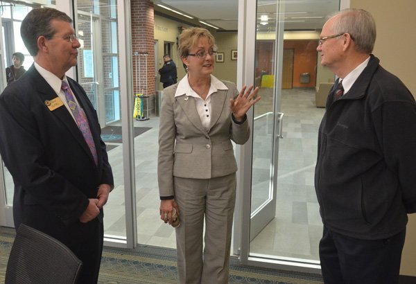 Ric Clifford with NorthWest Arkansas Community College, left, and Ken Ramey, superintendent of Siloam Springs School District, right, chat Wednesday with future Evelyn Jorgenson, future college president, during a drop-in coffee gathering at the college in Bentonville. The meet and greet gave area school superintendents a chance to chat with Jorgenson. 