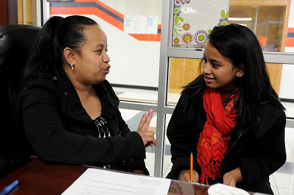 Mandy Ritok, Marshallese liaison for the Springdale School District, talks Wednesday with Ancelitha Abon, 13, an eighth-grader at Southwest Junior High School. Ritok works with Marshallese students to help with interpretation with them, their families and the school. Ritok said she really enjoys what she does and the students teach her as much as she teaches them.