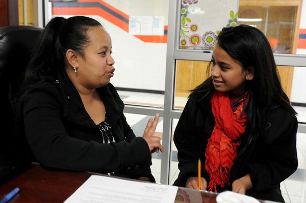 Mandy Ritok, Marshallese liaison for the Springdale School District, talks Wednesday with Ancelitha Abon, 13, an eighth-grader at Southwest Junior High School. Ritok works with Marshallese students to help with interpretation with them, their families and the school. Ritok said she really enjoys what she does and the students teach her as much as she teaches them.