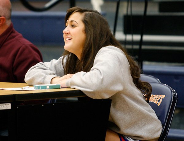 
Ali Johnson, a Rogers Heritage senior, sits at the scorers table during the War Eagles’ game against Rogers High on Tuesday at Rogers Heritage High School. After receiving a fourth concussion (three from playing soccer and one from basketball practice in the Spring), Johnson has not been medically released to play on the basketball team this season due to lingering symptoms.