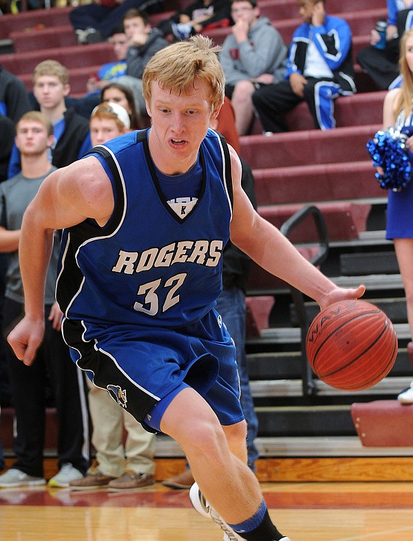         
Zach Jones of Rogers High drives into the key Jan. 4 game against Springdale High in Springdale.
ON THE MOVE 