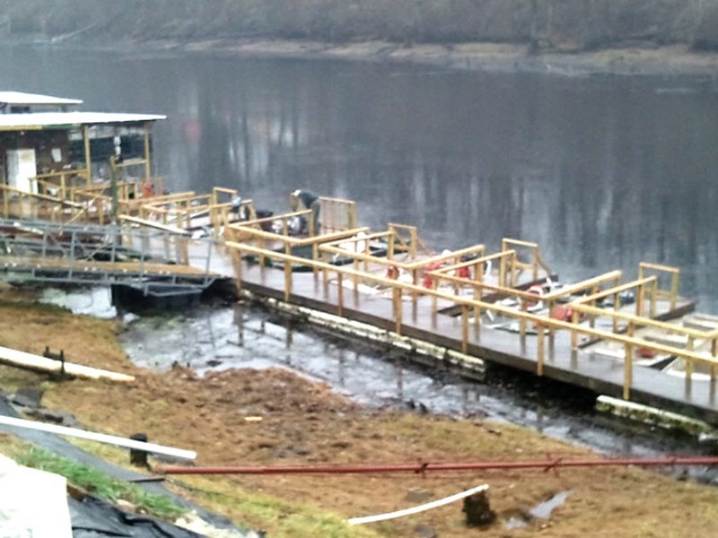 Crews are working to repair the dock at Lindsey's Resort on the Little Red River near Heber Springs and other damages resulting from the winter storm that hit the area Christmas Day.