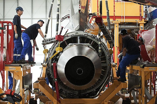 Workers assemble an engine on an Airbus SAS A320 airplane at the company’s plant in Tianjin, China, in June. China is investing heavily in expanding its civilian and military aerospace manufacturing in Tianjin. 