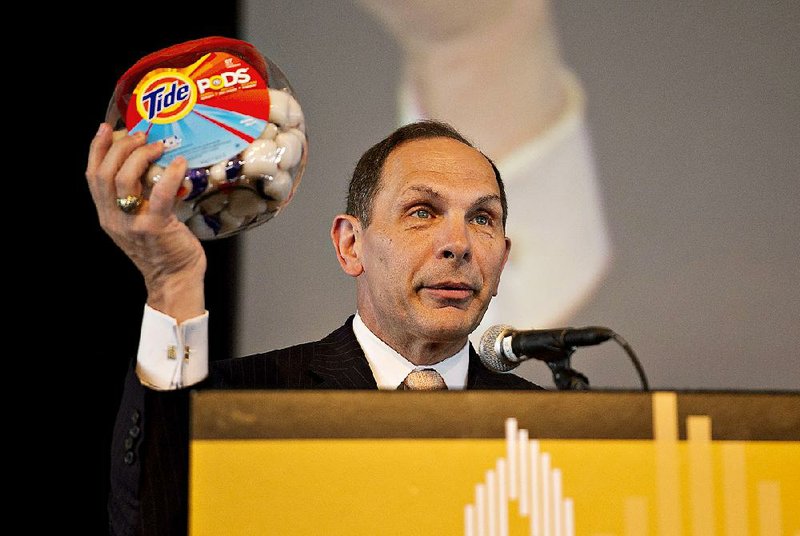 Robert McDonald, chairman, president and chief executive officer of Procter & Gamble Co., shows a package of Tide Pods detergent during a speech in Chicago in September. 