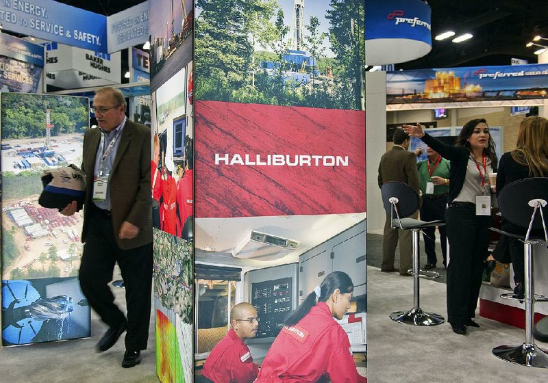 The Halliburton Co. booth is seen at the DUG Eagle Ford Conference & Exhibition in San Antonio in October. Halliburton said Friday that its fourth-quarter profit fell 26 percent. 