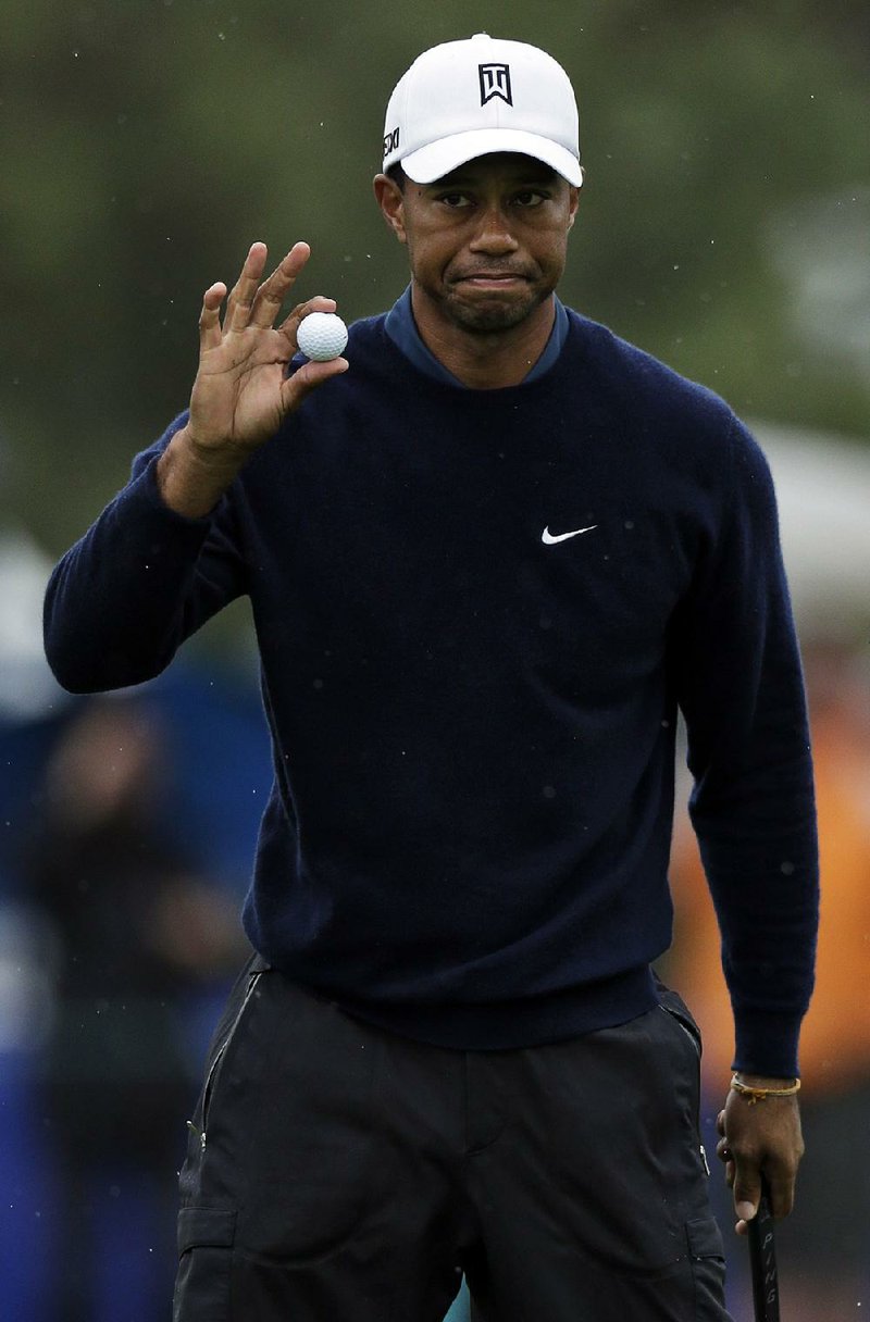 Tiger Woods shot a 7-under-par 65 at Torrey Pines North Course in San Diego on Friday and holds a two-shot lead at the Farmers Insurance Open. 