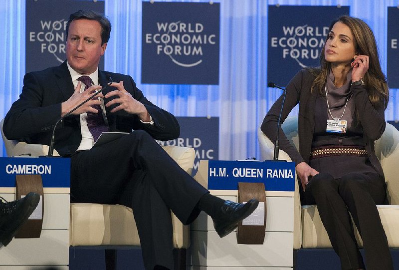 British Prime Minister David Cameron, seated next to Queen Rania of Jordan, speaks Thursday at the World Economic Forum in Davos, Switzerland. 