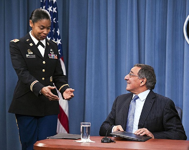 Army Lt. Col. Tamatha Patterson of Huntingdon, Tenn., waits Thursday at the Pentagon for Defense Secretary Leon Panetta to hand her the memorandum he had just signed that ends the 1994 ban on women serving in combat. 