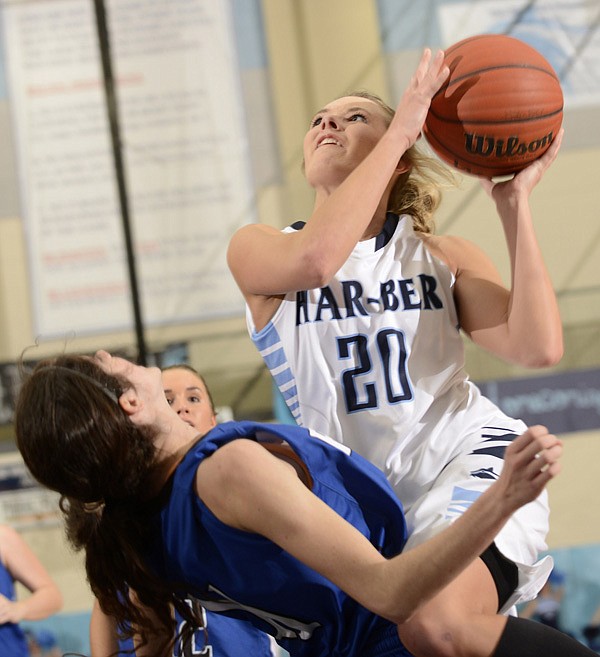 Caylee Wright, right, of Springdale Har-Ber charges into Rogers’ Hannah Hawley on her way to the basket during Friday’s game in Springdale. 