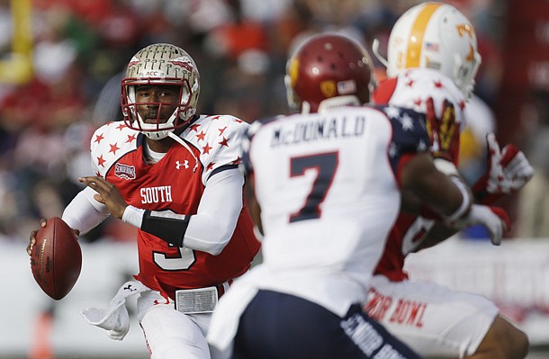 Senior Bowl South Squad quarterback EJ Manuel of Florida State (3) looks for a receiver as North Squad defensive back TJ McDonald of USC (7) covers South Squad tight end Mychal Rivera of Tennessee (81) in the first half of the Senior Bowl college football game at Ladd-Peebles Stadium in Mobile, Ala., Saturday, Jan. 26, 2013. (AP Photo/Dave Martin)