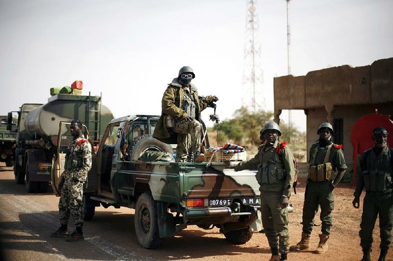 Malian soldiers linger in the town of Konna in this photograph taken during an official visit organized by the Malian army. 