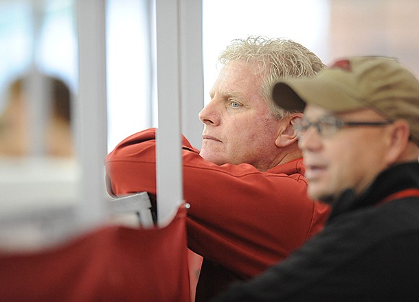 NWA Media/ANDY SHUPE -- Arkansas coach Chris Bucknam, left, and assistant Danny Greene watch Saturday, Jan. 26, 2013, during the Razorback Invitational at the Randal Tyson Track Center in Fayetteville.