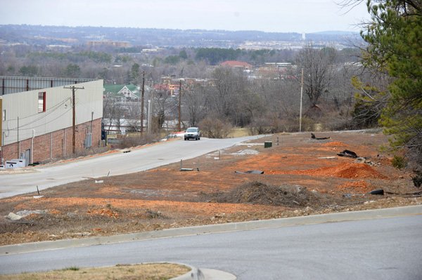 Several residential lots sit vacant on land east of the Evelyn Hills Shopping Center. A Springdale-based developer has plans to build apartments on the 2.2-acre property. Bart Bauer said Friday he wants to build four, four-unit apartment buildings just east of the shopping center. 