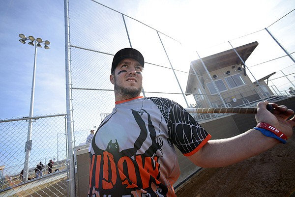 Brandon Allen of Fredonia, Kan., stretches Saturday before taking his first at bat during the first inning of team Widow Makers’ lower division game against the P.J. All Stars in the 32nd annual Snowball Classic softball tournament at the Regional Sports Complex in Rogers. The three-day tournament is the oldest running winter softball tournament in the U.S. and features 35 teams competing in upper, lower and co-ed divisions from around Northwest Arkansas and neighboring states. Allen’s team is based out of southeast Kansas. The tournament concludes today and runs from 10 a.m. to 5 p.m. 