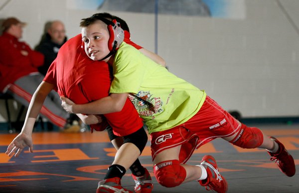 Brendan Davis, left, 12, and Gavin Goddard, 10, wrestle during practice Jan. 21 inside The Annex in Rogers. 