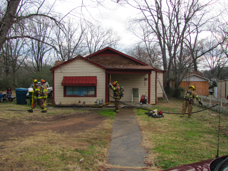 Crews pack up after extinguishing a fire at 3409 Walker St. Monday morning in Little Rock.