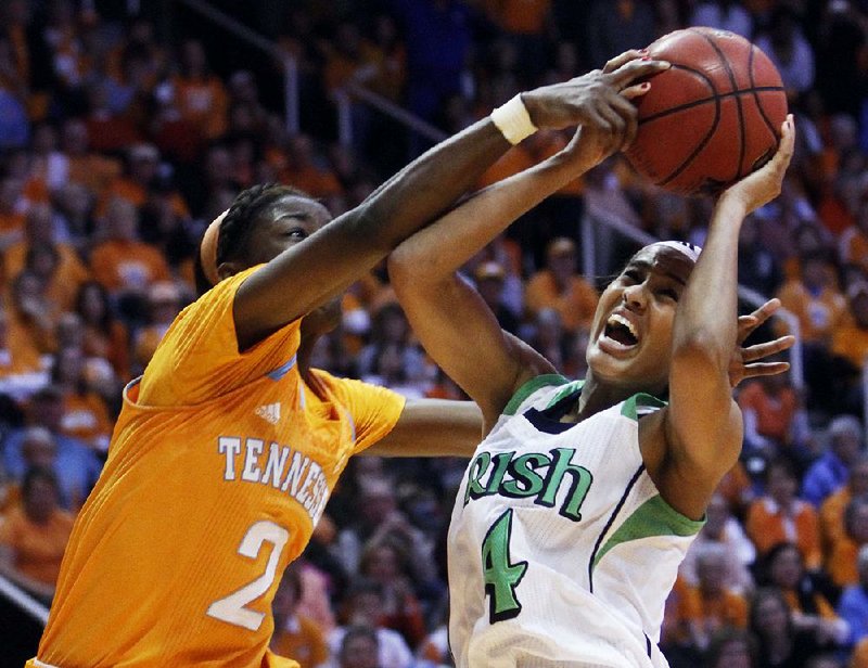 Notre Dame guard Skylar Diggins (4) is fouled by Tennessee forward Jasmine Jones (2) during the second half of Monday’s game in Knoxville, Tenn. Diggins led the Irish with 33 points as Notre Dame won its 14th consecutive game, topping the Lady Volunteers 77-67. 