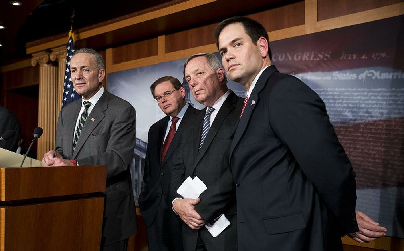 A bipartisan group of senators (from left), Chuck Schumer, D-N.Y., Robert Menendez, D-N.J., Dick Durbin, D-Ill., and Marco Rubio, R-Fla., announce that they have reached agreement on the principles of sweeping legislation to rewrite the nation’s immigration laws during a news conference Monday at the Capitol in Washington. 