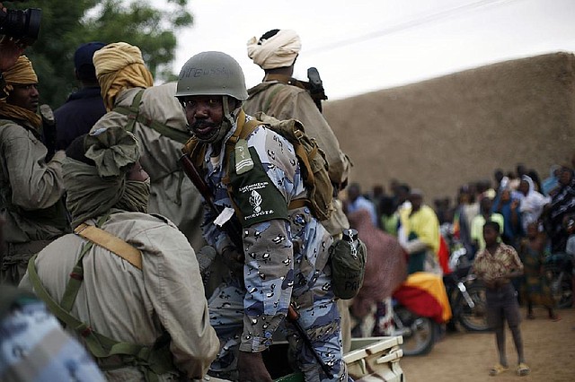 Chadian soldiers, assisted by Malian gendarmes, patrol the streets of Gao in northern Mali on Monday. 