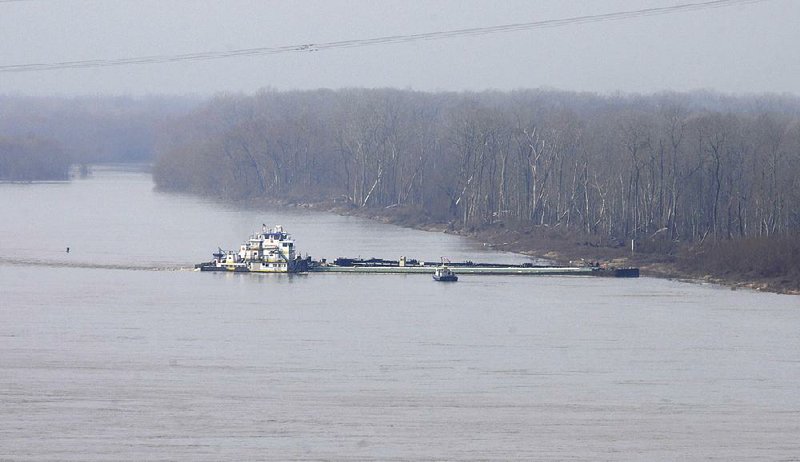 The towboat Nature’s Way Endeavor banks a barge against the western bank of the Mississippi River near Vicksburg, Miss., on Monday. 