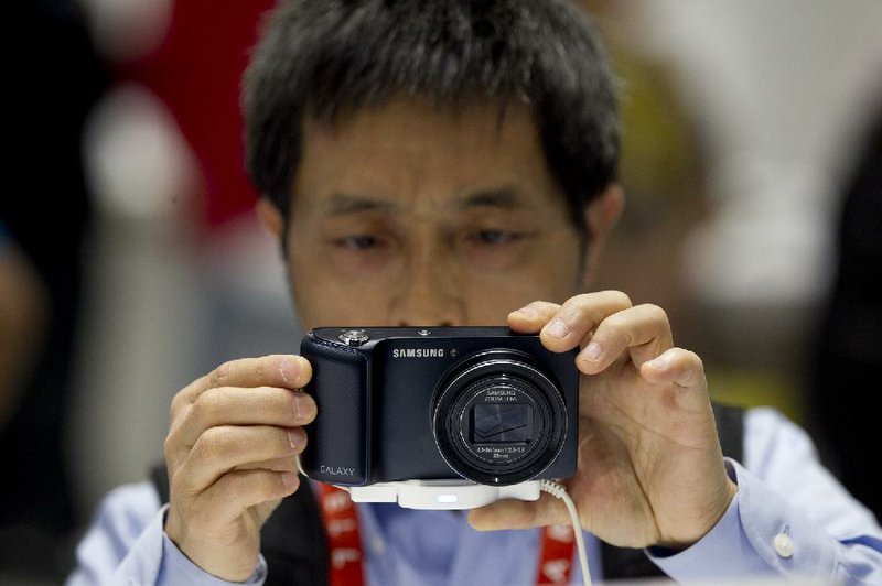 Yingen Xiong examines a Samsung Electronics Co. Galaxy camera during the 2013 Consumer Electronics Show in Las Vegas earlier this month. 