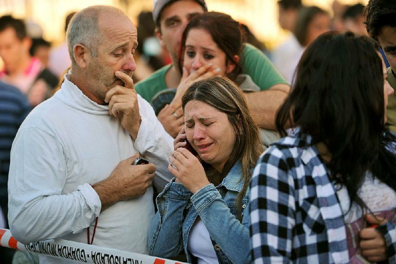 Relatives of victims react as they wait for news in front of the Kiss nightclub in Santa Maria, Brazil, on Sunday. 