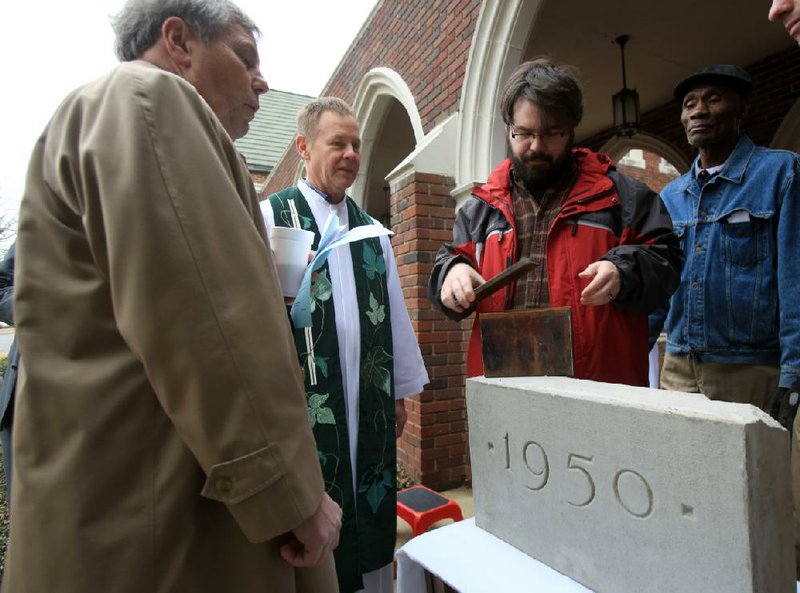 Jacob Nolen (second from right), Pulaski Heights United Methodist Church director of technology, along with Skip Rutherford (from left), the Rev. Britt Skarda and Nate Lewis, puts the lid on a time capsule before it is placed in the church’s cornerstone during a service Sunday morning at the Little Rock church. 